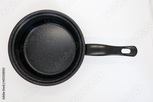 Black and red non-stick pan for cooking in the kitchen, isolated on white