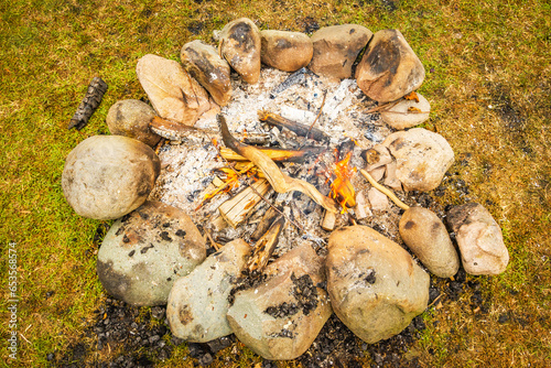 Campfire in nature in stones stacked in a circle