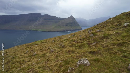 Villingardalsfjall mountain slope with view of Bordoy and foggy Kunoy Island in Faroe Islands. Aerial photo