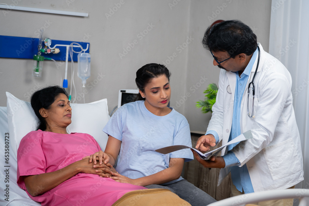 Obraz premium Confident doctor explaining Patients health report to daughter at hospital ward - concept of Family Support, Medical Discussion and Healthcare Update