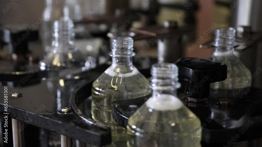 Vinegar Factory of Plastic Bottles Being Filled with a Close Up Shot Using Automated Machines. Vinegar Factory of Plastic Bottles Being Filled with a Close Up Shot Using Automated Machines.