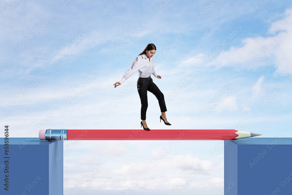 Attractive young european female crossing pencil bridge on sky background. Career problem and gap concept. Attractive young european female crossing pencil bridge on sky background. Career problem and gap concept.