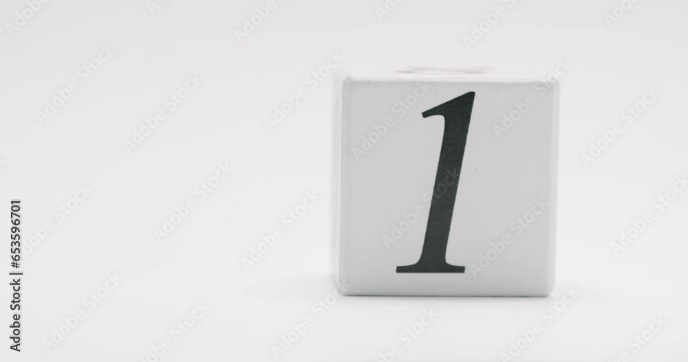 Person hand puts cube with number one on table on white background. Teach math symbol. Winner concept. Person hand puts cube with number one on table on white background. Teach math symbol. Winner concept.