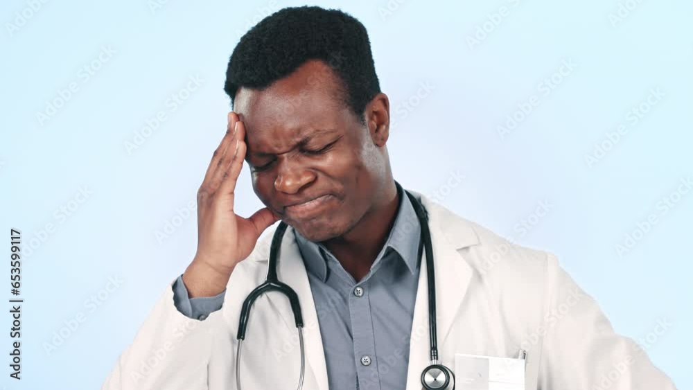 Man, doctor and headache or stress for healthcare results, hospital mistake and crisis on a blue background. Medical worker or african person with anxiety, pain and decision or clinic fail in studio Man, doctor and headache or stress for healthcare results, hospital mistake and crisis on a blue background. Medical worker or african person with anxiety, pain and decision or clinic fail in studio
