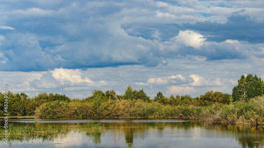 clouds over lake anf forest