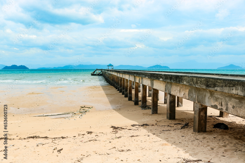 Pier against the backdrop of a beautiful azure bay in a transparent sea, vacation, travel, dream. Copy space.