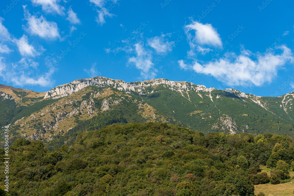 Baldo Mountain (Monte Baldo) in summer, east side, seen from the small village of Ferrara di Monte Baldo, Verona province. Mountain range between Lake Garda and Adige Valley, Italian Alps. Italy.