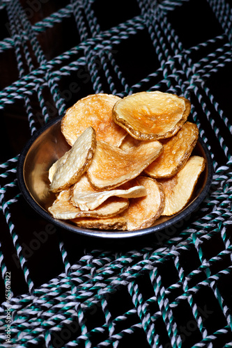 A plate of golden colored homemade fried potato chips