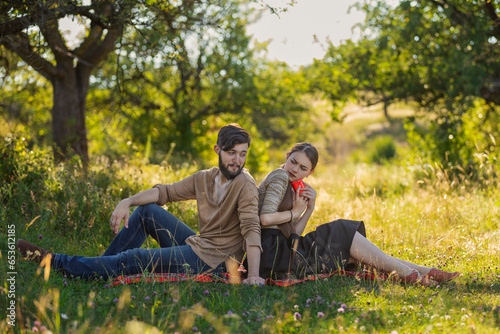 Fotografía Young couple in nature, a girl with a phone is texting someone