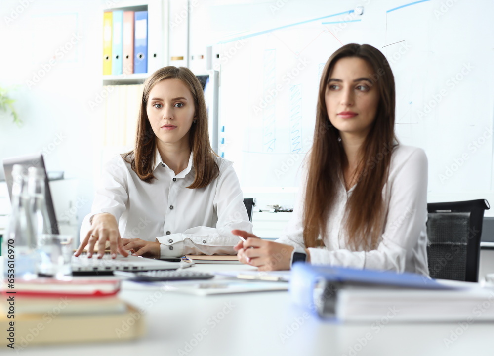 Portrait pretty business lady looking at camera with calmness of smart businesswoman sitting indoors and discussing important topic. Accounting office concept Portrait pretty business lady looking at camera with calmness of smart businesswoman sitting indoors and discussing important topic. Accounting office concept