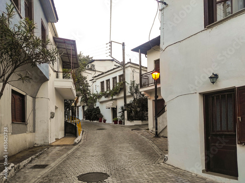 Fototapeta Naklejka Na Ścianę i Meble -  Narrow paved street with specific architecture of the houses , in rustic Panagia village , up on the hills of Thassos Island , Greece