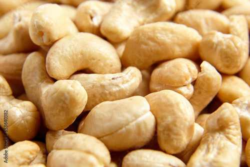 Cashew nut heap food texture background, macro shot. Many shelled cashews