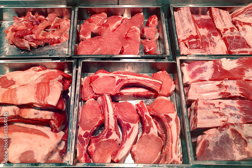 Butcher shop fridge counter with cold raw meat
