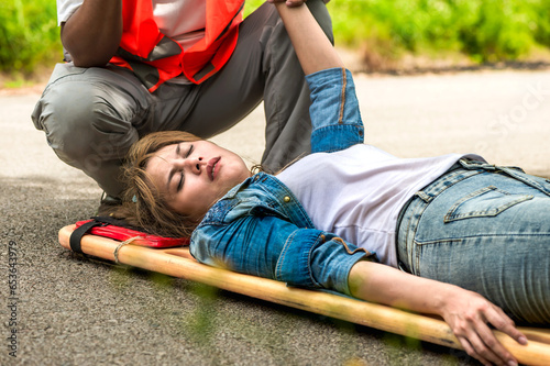 Injury woman lying on emergency stretcher after car accident 