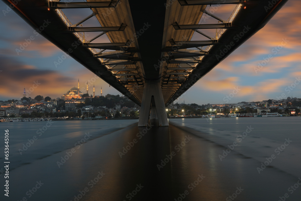 New Halic Metro Bridge at summer night blue sky and city lights in Istanbul, Turkey