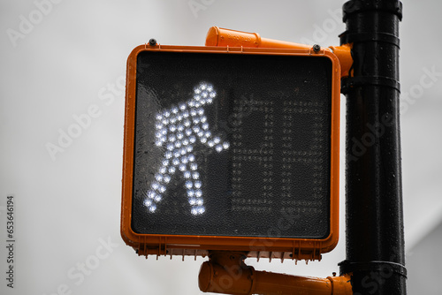 White pedestrian traffic light showing that you are allowed to cross the street. Pedestrian traffic signs industry. photo
