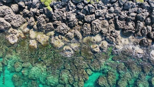 Top view of seawaves reaching shore and coral reef with 4K drone view photo