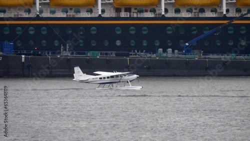 Cessna Caravan C208 Seaplane in the Harbor with Ships in Background photo