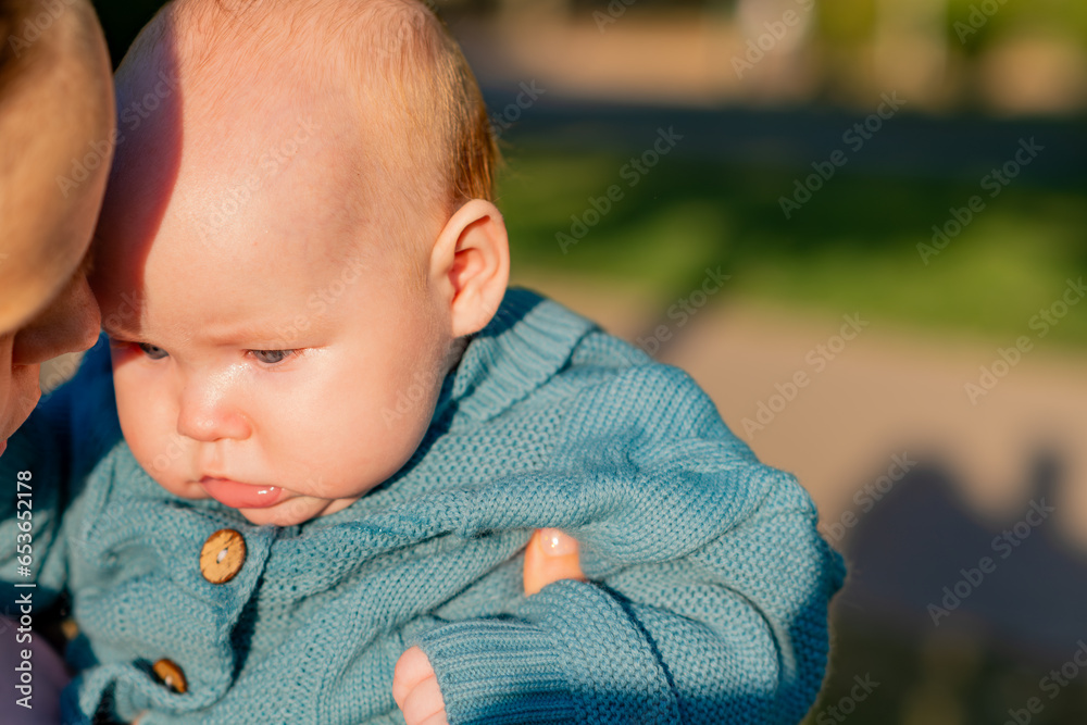 Close-up portrait of a newborn baby in the arms of his mother Close-up portrait of a newborn baby in the arms of his mother
