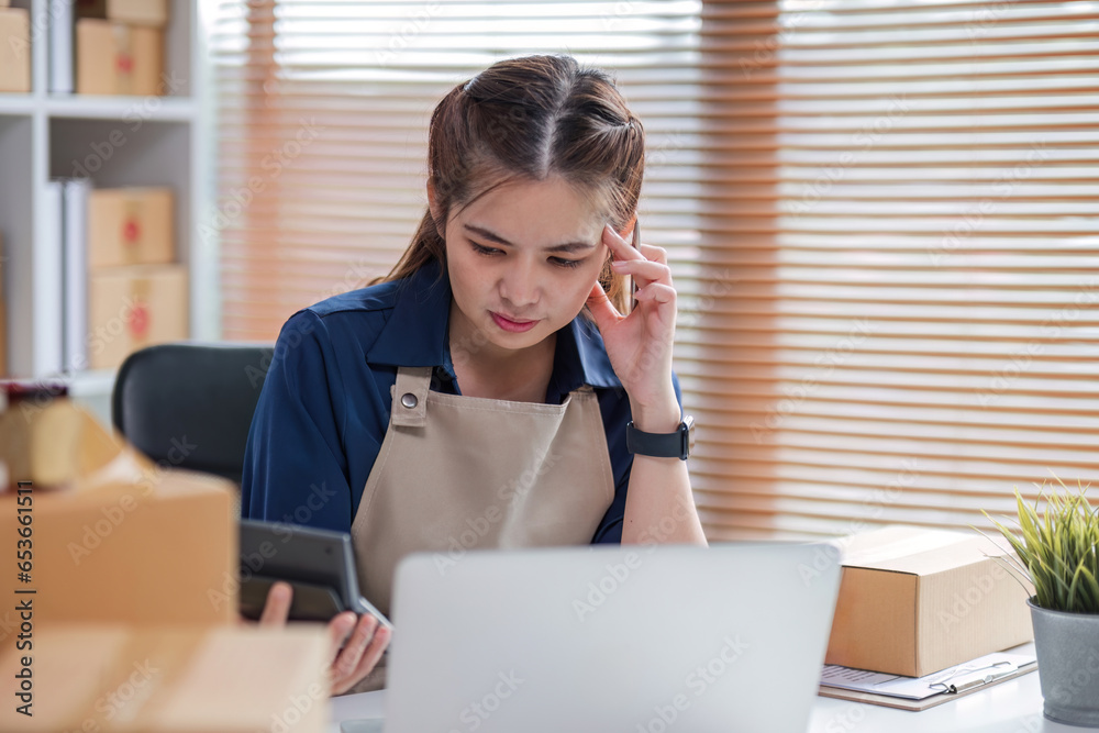 SME business entrepreneurs who conduct online sales businesses Sitting stressed while checking product management documents. SME business entrepreneurs who conduct online sales businesses Sitting stressed while checking product management documents.
