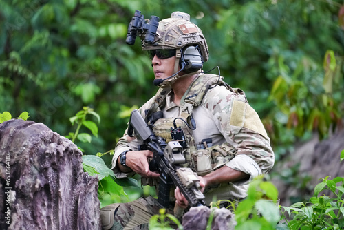 Quadro em tela Military army soldiers tactical team, commando group moving cautiously in forest area, kneeling and looking around, covering comrades, controlling sectors