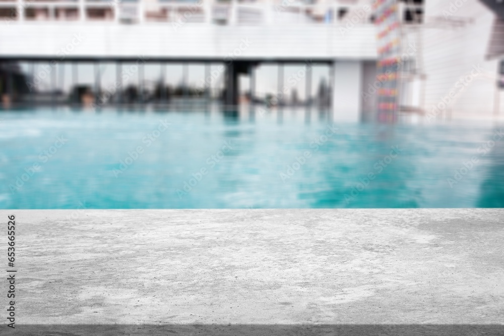 Empty blank table top on swimming pool background