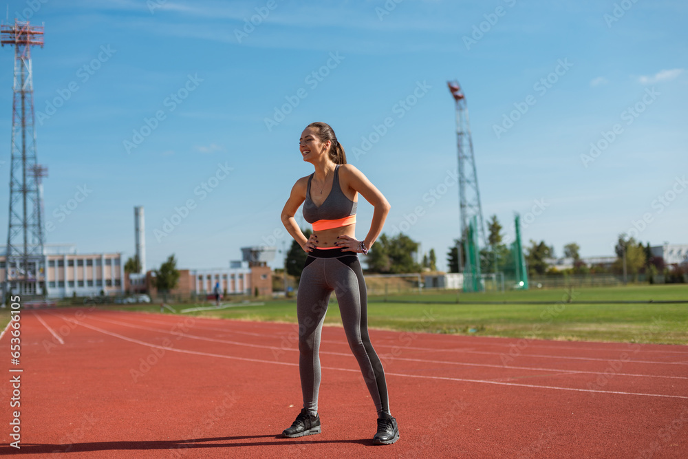 Beautiful woman training on the tracks on a sunny morning