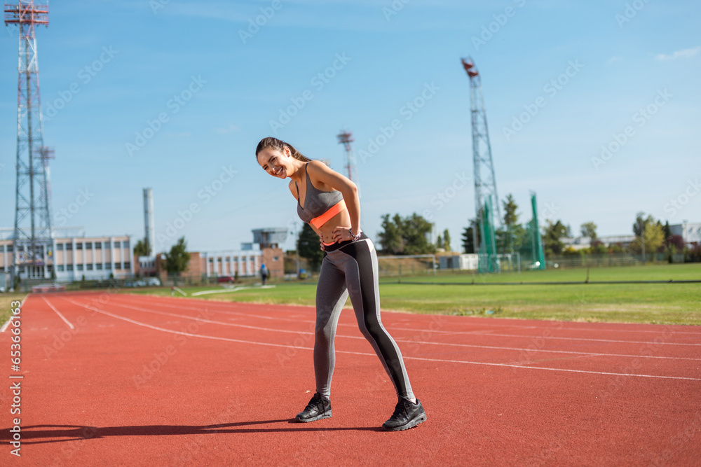 Beautiful woman training on the tracks on a sunny morning