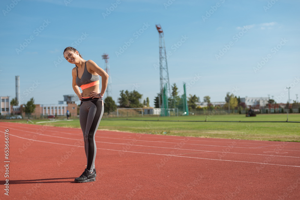 Beautiful woman training on the tracks on a sunny morning