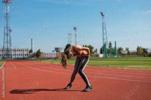 Obraz na płótnie Beautiful woman training on the tracks on a sunny morning w salonie
