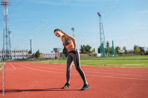 Obraz na płótnie Beautiful woman training on the tracks on a sunny morning w salonie