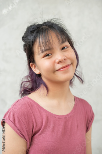 Happy teen girl 11-15 year old. Portrait beautiful woman smiling with perfect smile and white teeth. asian lady girl wear casual cloth with smiling looking at camera on gray background.