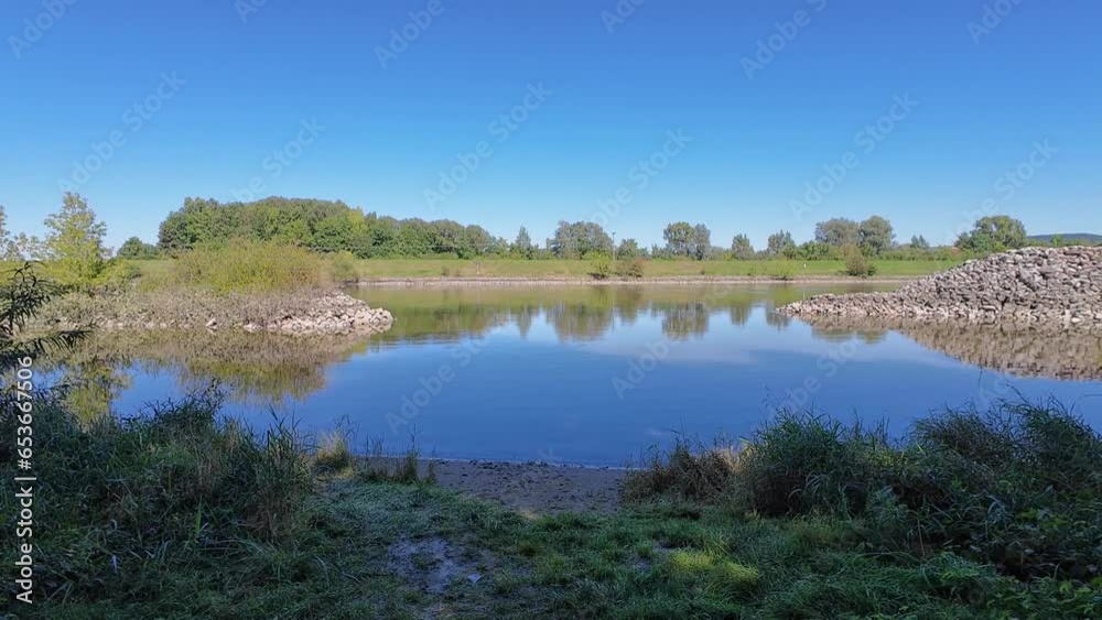 Groyne fields on the blue Danube with overgrown banks in an idyllic landscape in Bavaria Groyne fields on the blue Danube with overgrown banks in an idyllic landscape in Bavaria