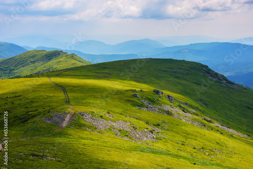 carpathian landscape in summer. rolling hills of watershed ridge in dappled light. travel ukraine