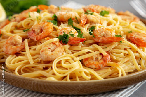 Baked Shrimp Scampi Linguine Pasta with Parsley on a Plate  side view. Close-up.