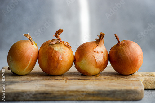 Raw organic onion heads on the table photo