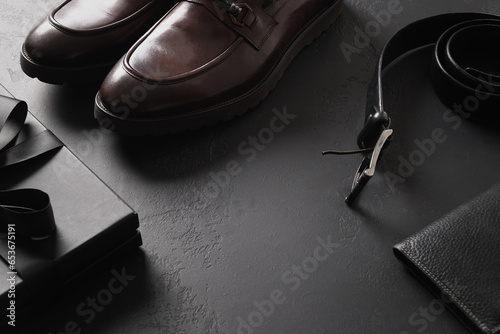 Fotografie Father's Day composition of classic mens accessories - shoes, belt and gift on black background