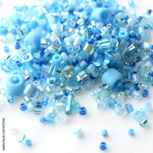 Mix of beads of different shapes and sizes on a white background