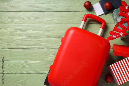 A suitcase with a festive hat and gifts