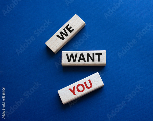 We want you symbol. Concept words We want you on wooden blocks. Beautiful deep blue background. Business and We want you concept. Copy space.