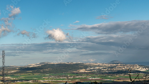 Panoramic view of part of the Jezreel Valley with Kfar Yehoshua, Migdal Haemek, Mount Tabor and Nazereth on a rainy day in Israel. 