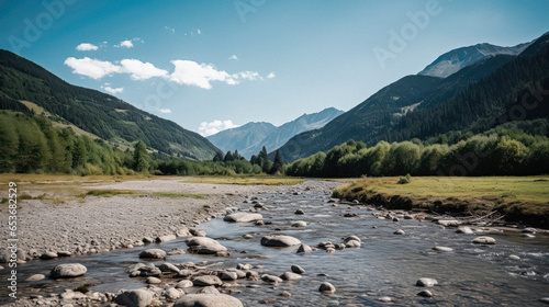 A river flows through a lush green valley surrounded by snow-capped mountains. The river is a winding ribbon of blue, and the mountains are a backdrop of white and gray. Beauty of nature.