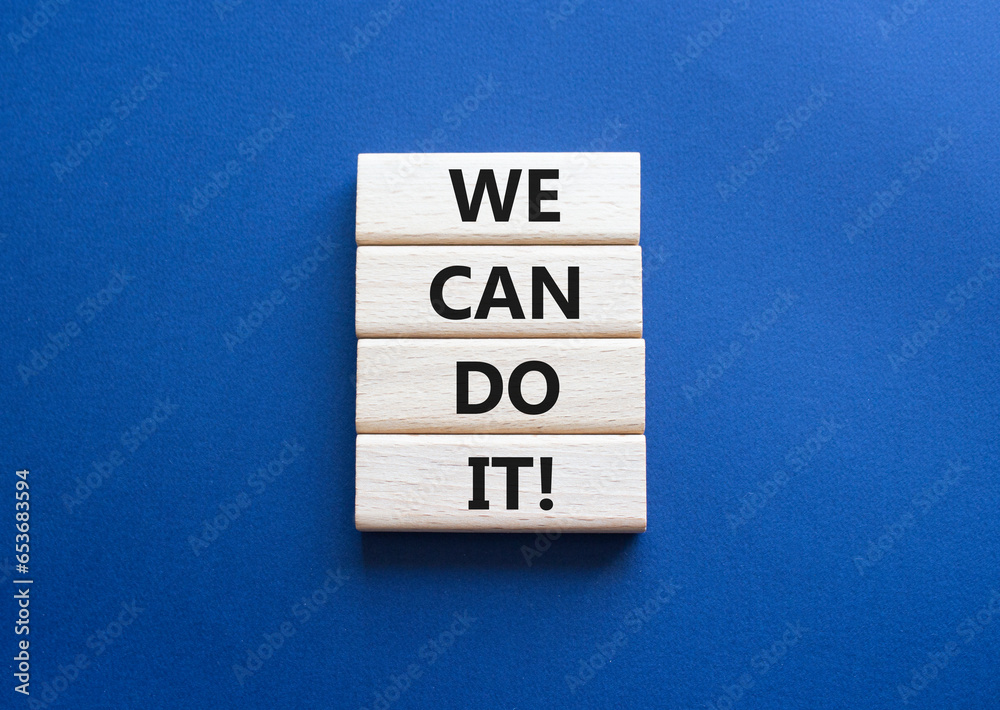 We can do it symbol. Concept words We can do it on wooden blocks. Beautiful deep blue background. Business and We can do it concept. Copy space.