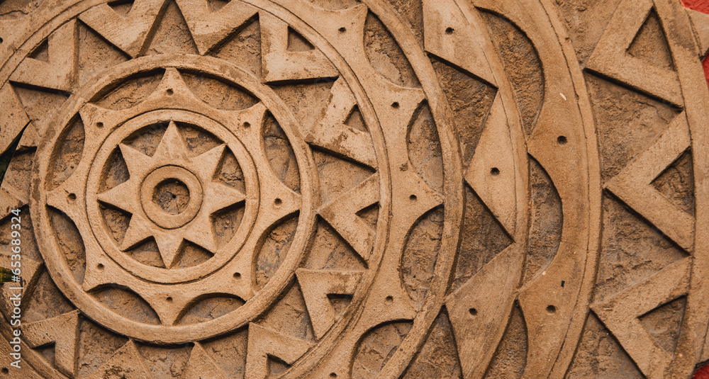 detail of mandala made of cement. background texture with brown mandala