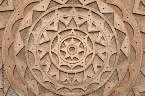 mandala texture made of cement. Background with brown mandala