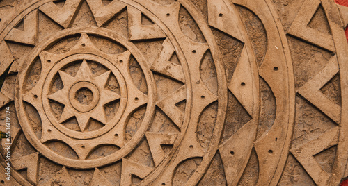 detail of mandala made of cement. background texture with brown mandala