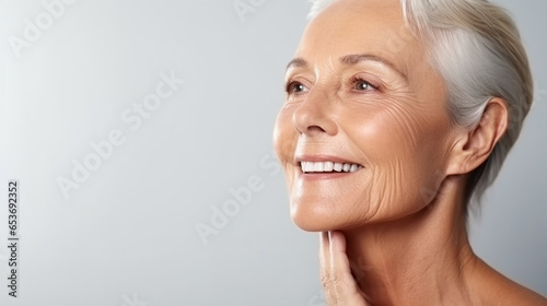 A close-up of a mid-age beautiful elderly senior woman, face skin care beauty photo