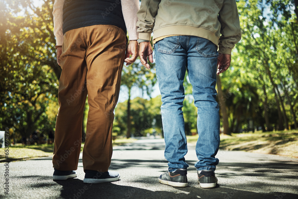 Walking, park and back of men on path for wellness, fresh air and health outdoors to relax. Friends, fitness and legs of people on path in nature to relax for training, exercise and cardio workout