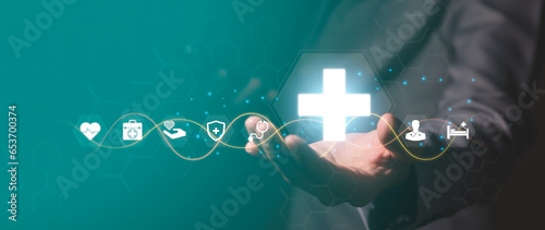 Fototapeta Naklejka Na Ścianę i Meble -  Businessman holds virtual medical network connection icon. The epidemic spreads and spreads interest in healthcare. Increased growth in the hospital and health insurance business