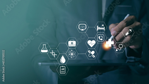 Fototapeta Naklejka Na Ścianę i Meble -  Businessman using mobile phone with modern interface and touching medical service network connection icons and health insurance business